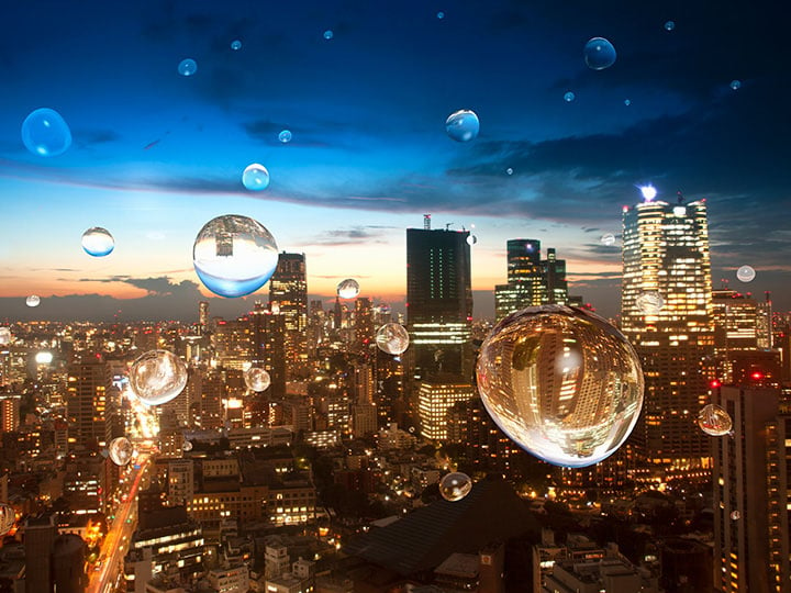 Water drops on a window overlooking a cityscape at sunset