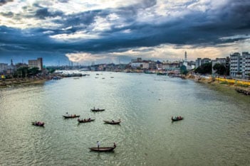 Paddle boats in a large urban river